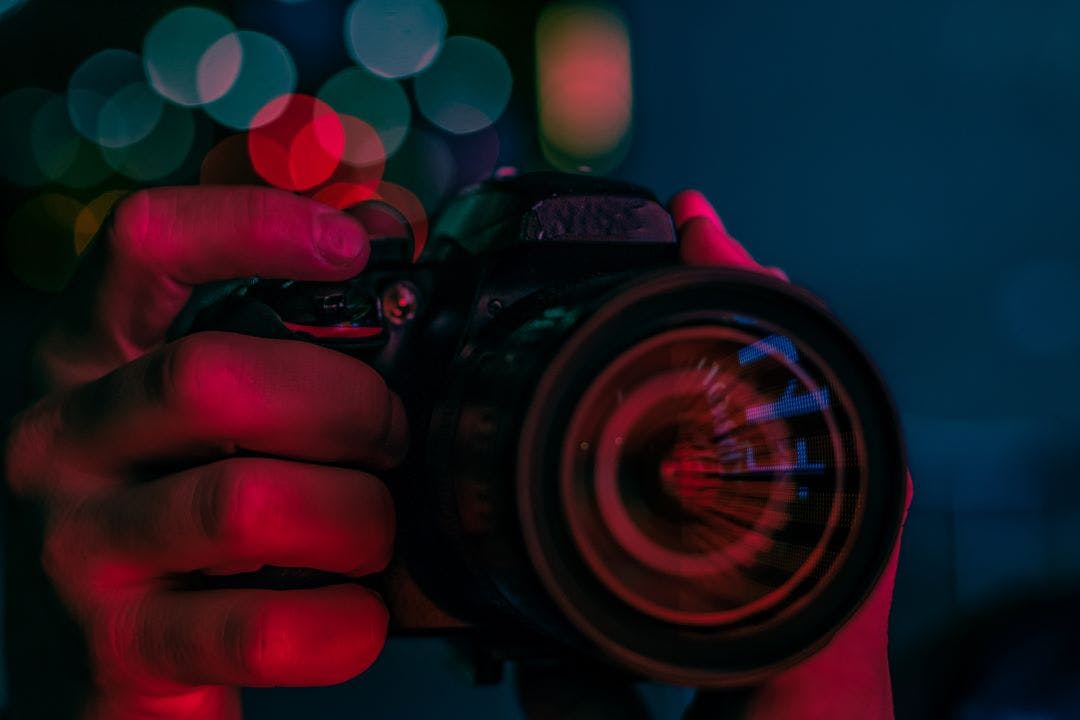 close abstract of a photographer hand taking picture A Quick Guide to Motorcycle Photography 101