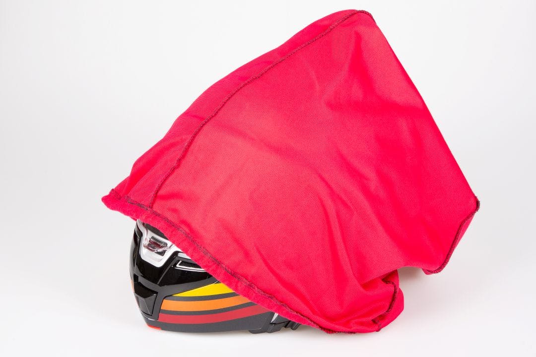 Motorcycle Helmet in red carrying and protection bag How to Travel With Your Motorcycle Gear on a Plane