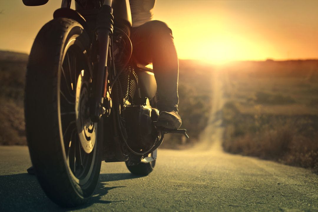 On a roaring motorcycle at sunset Best States to Ride a Motorcycle Year-Round