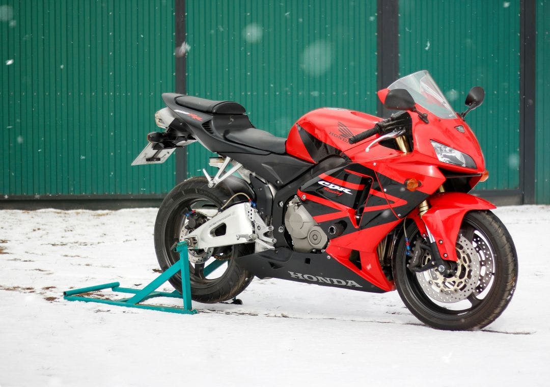 Red and black sportbike Honda CBR 600 RR 2005 PC37 in winter Tips for How to Store Your Motorcycle for Winter