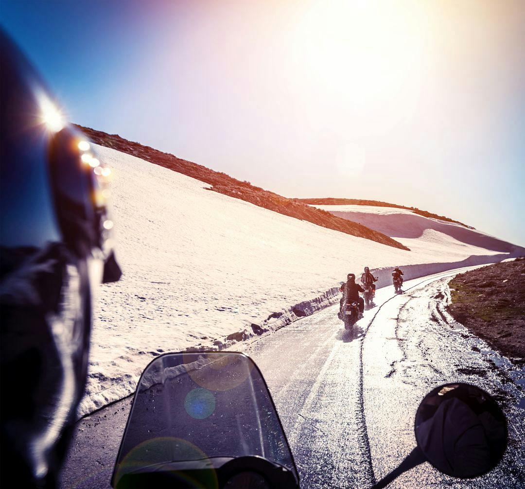 Group of bikers on snowy road How to Stay Warm on a Motorcycle