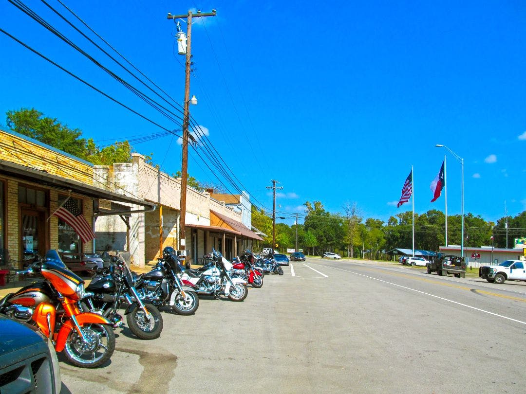 Parking motorcycles in a row along the street List of San Antonio Motorcycle Clubs that Fit Your Riding Style