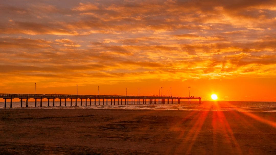 Sun rising behind pier in Port Aransas TX Best 15 Day Trips from San Antonio, Texas