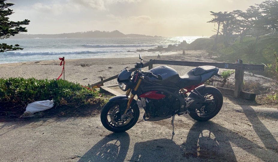 Picture of a 2016 Triumph Speed Triple R motorcycle parked on a beautiful beach in California