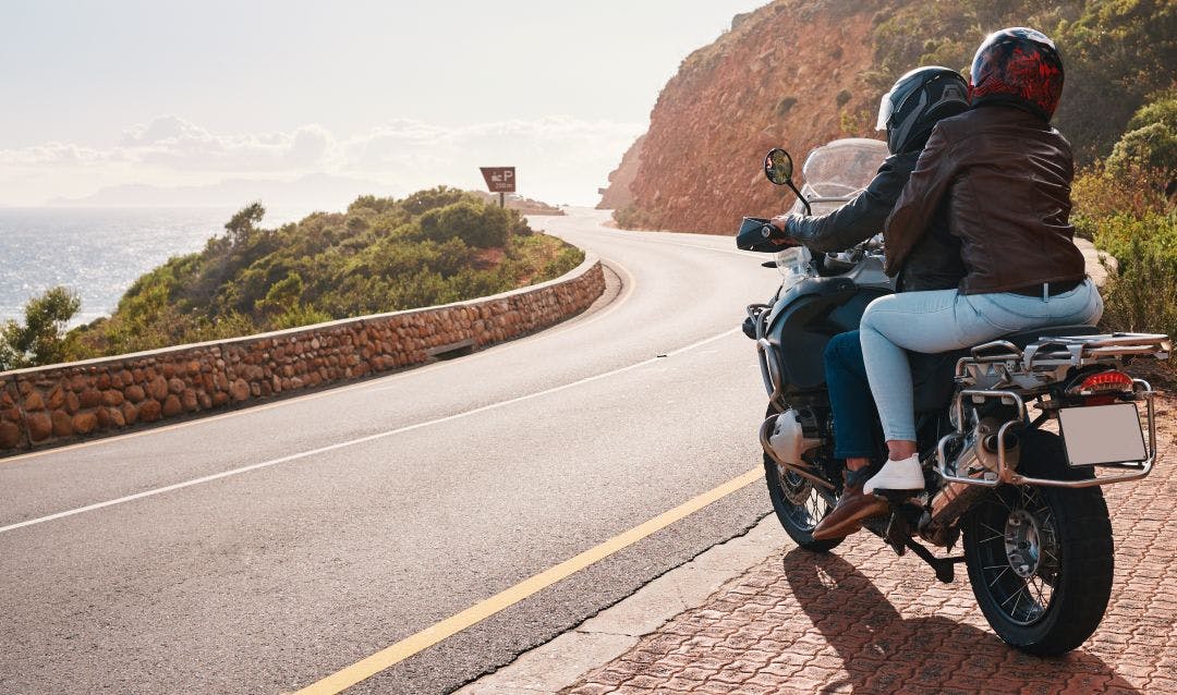 Motorcycle, travel and back of couple on road for adventure, freedom and enjoy weekend on mountain. Love, travelling mockup and man and woman ride on motorbike for holiday, vacation and journey Compare Renting a Motorcycle For a Day Vs. Week