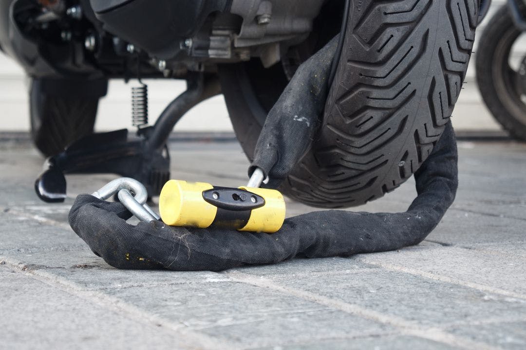 This is a secure motorcycle lock that features a heavyduty chain combined with a padlock Motorcycle Travel: Keeping Your Bike Locked & Safe