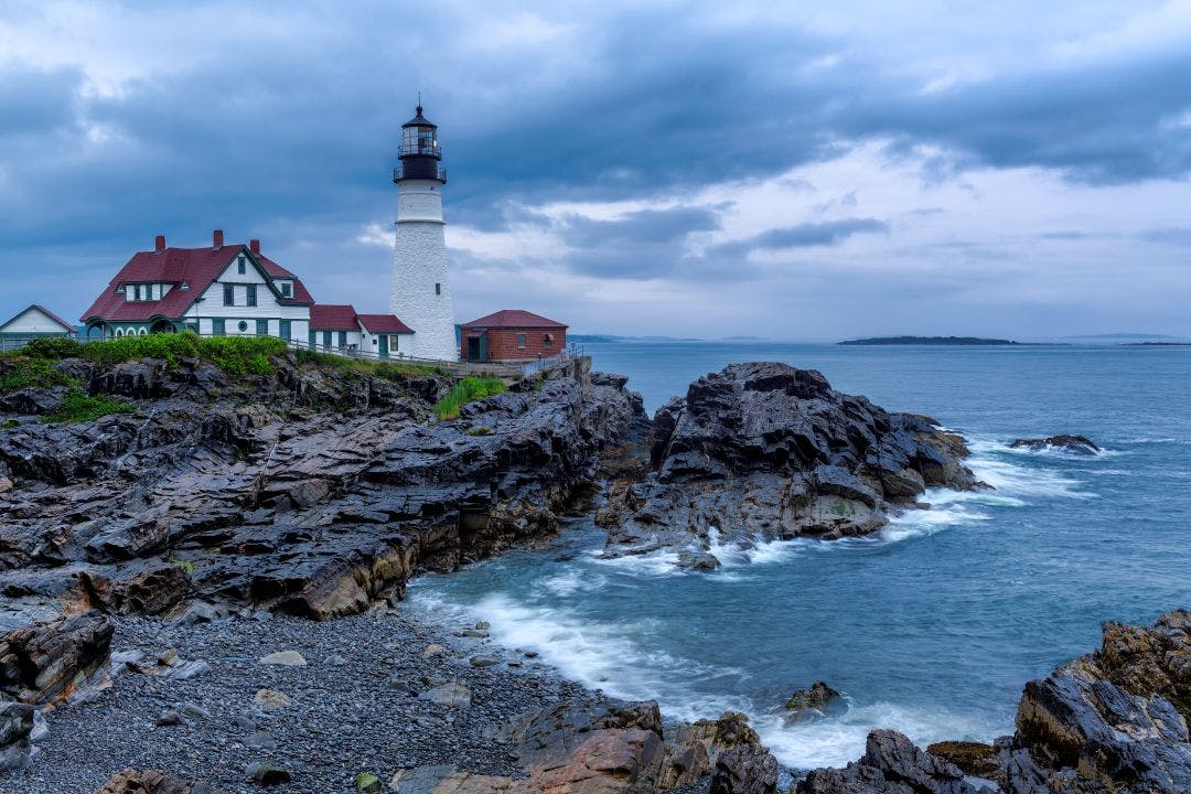 Portland Head Lighthouse at morning with stormy dramatic sky in New England, Maine, USA Best Motorcycle Routes & Rides in New England