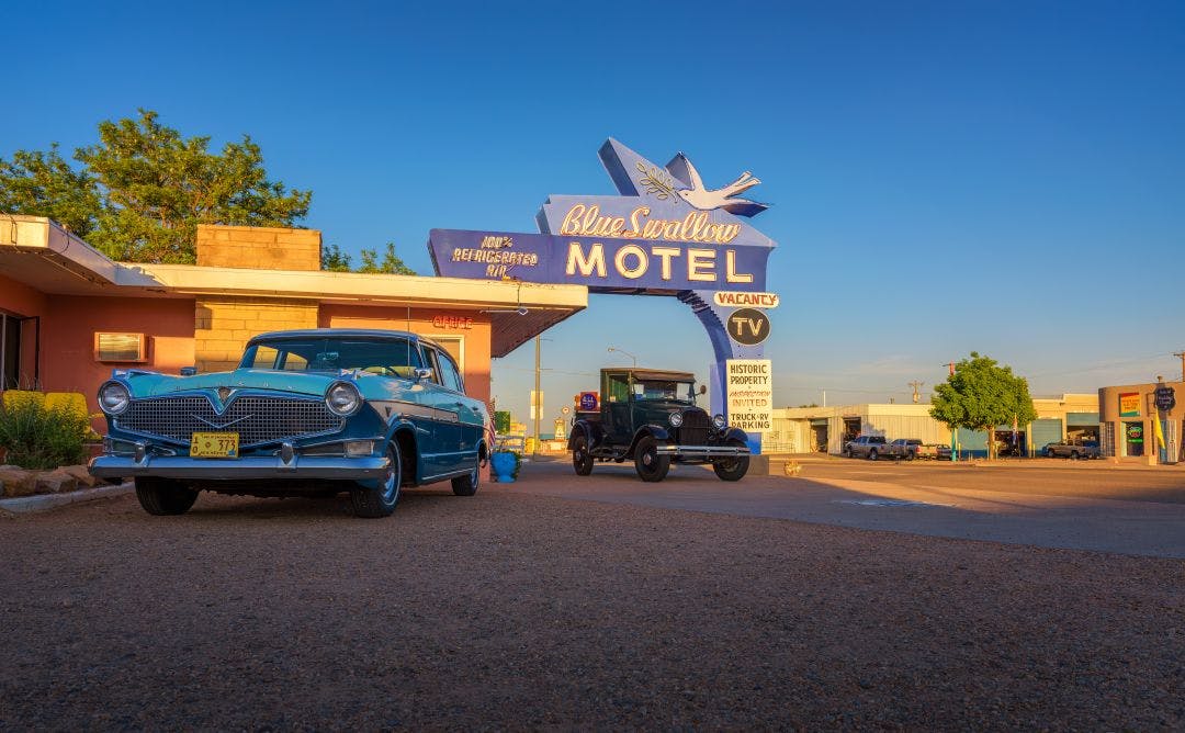 Tucumcar New Mexico historic blue swallow motel with vintage cars hudson and ford parked in front 14-Day Route 66 Self-Guided Motorcycle Tour: All You Need