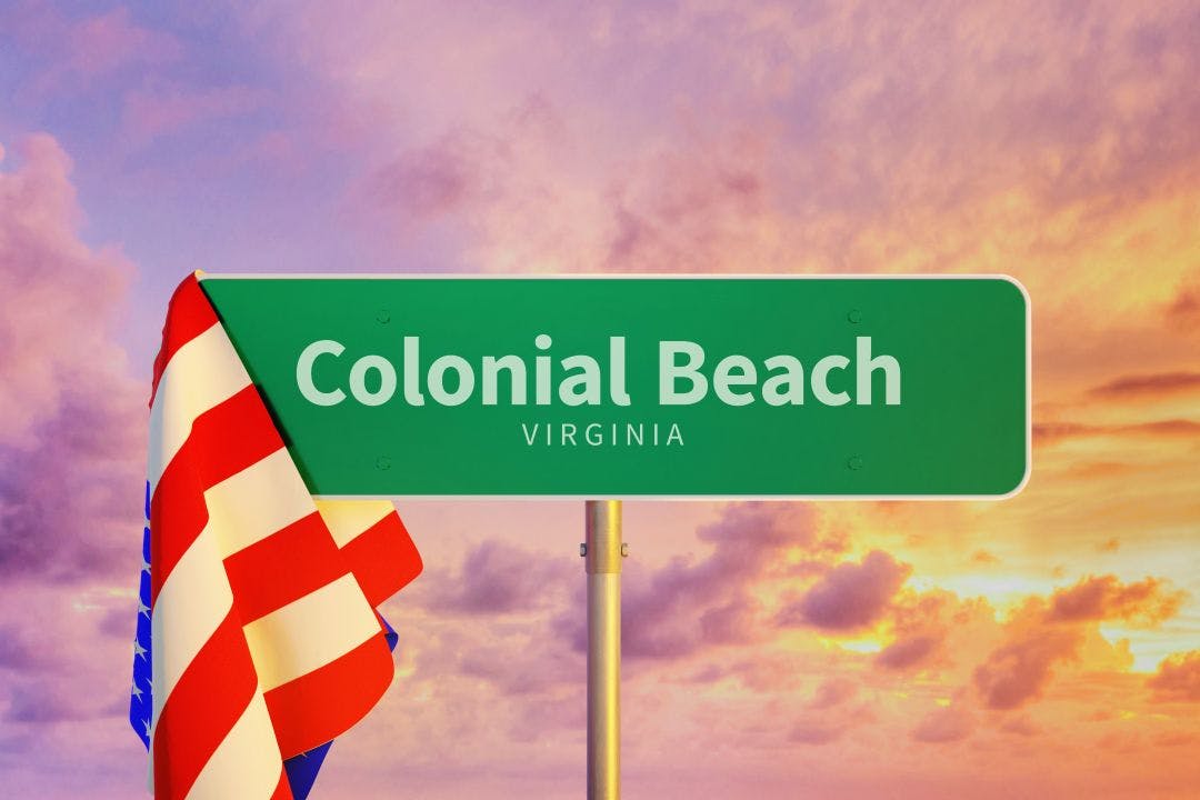 colonial beach virginia road sign with american flag and sunset in background Colonial Beach Bike Fest 2025 | Virginia Bike Week Oct 9–12