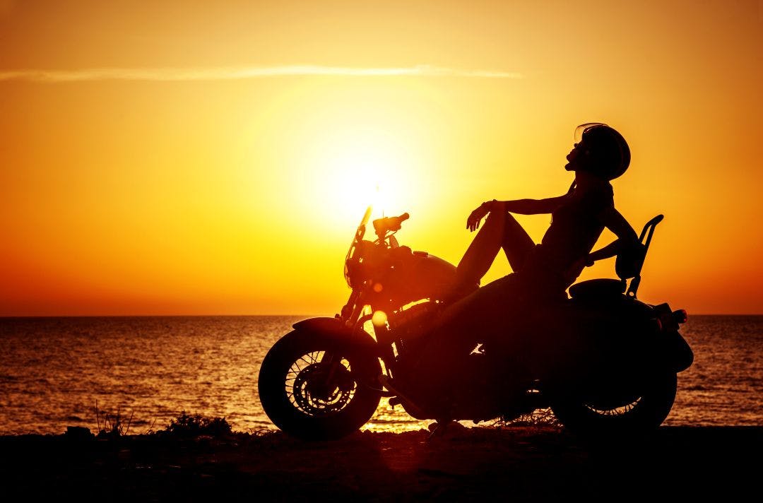 woman biker enjoying susent on the beach Colonial Beach Bike Fest 2025 | Virginia Bike Week Oct 9–12