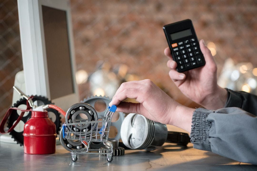 worker is calculating the price of motorcycle spare parts with calculator concept Are Motorcycle Sales Declining? The Truth