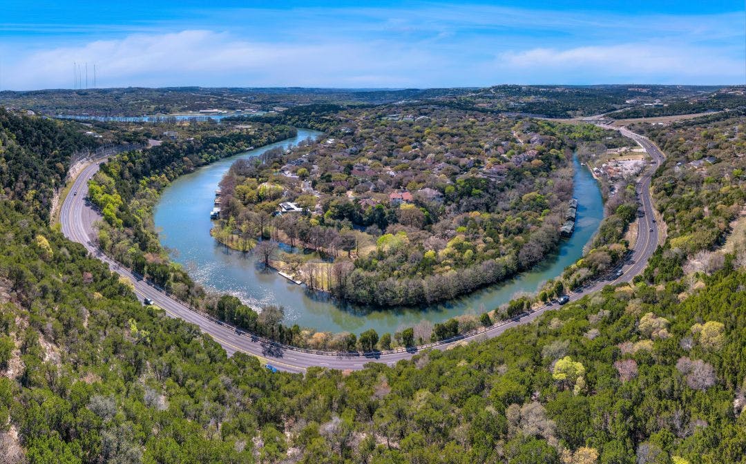 austin texas view from top of a slope with highway at the bottom near the colorado river The Twisted Sisters Texas | Ranch Road 335, 336, 337 Guide
