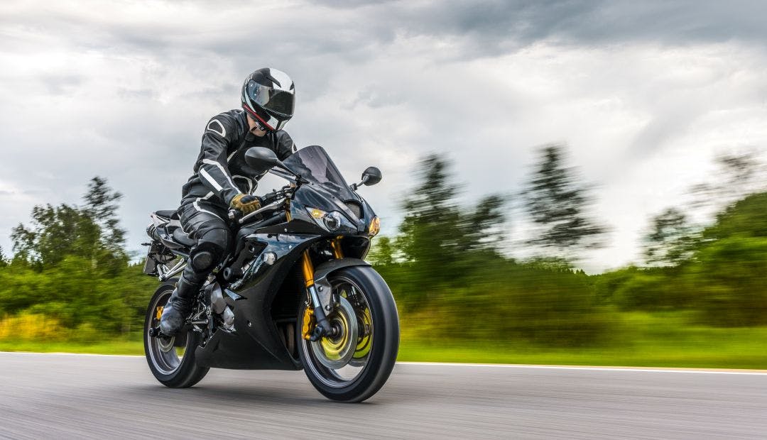 man on sport bike on the road having fun Sport Bike Rentals | Ducati, R1, Ninja Requirements