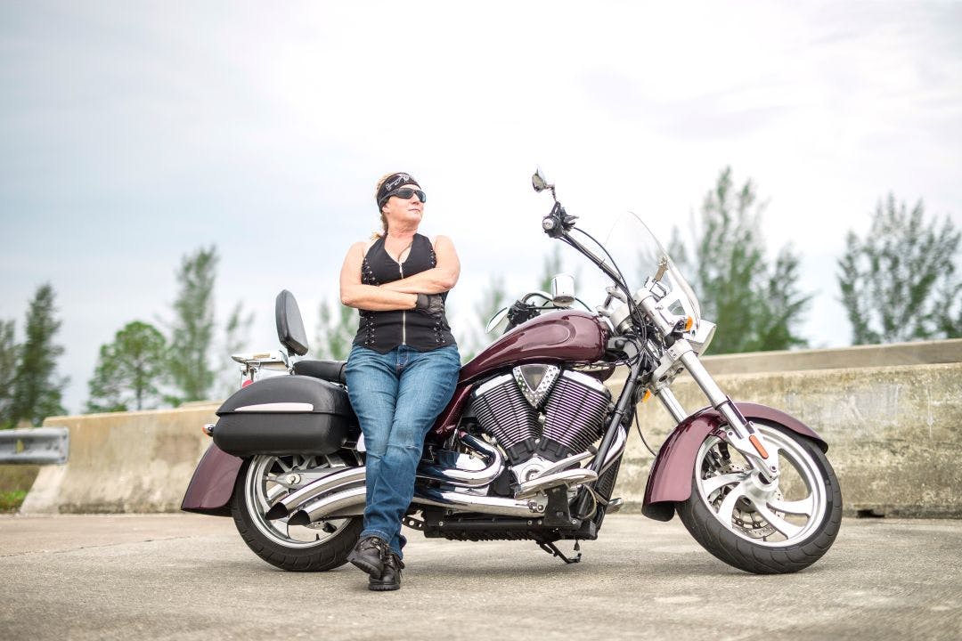 female biker or woman motorcycle rider in florida with arms crossed Florida Motorcycle Rental Costs 2026: Prices by City