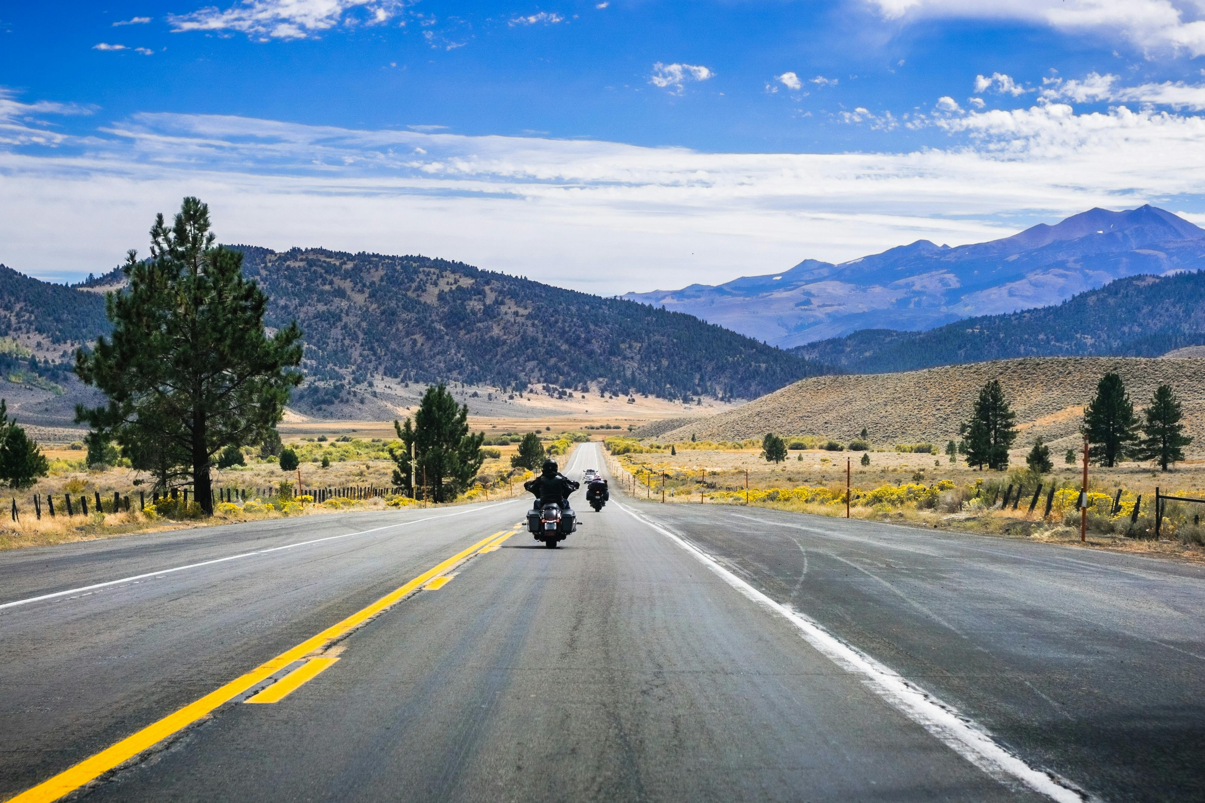 image of motorcycle rider riding down a road - anti instagram travel