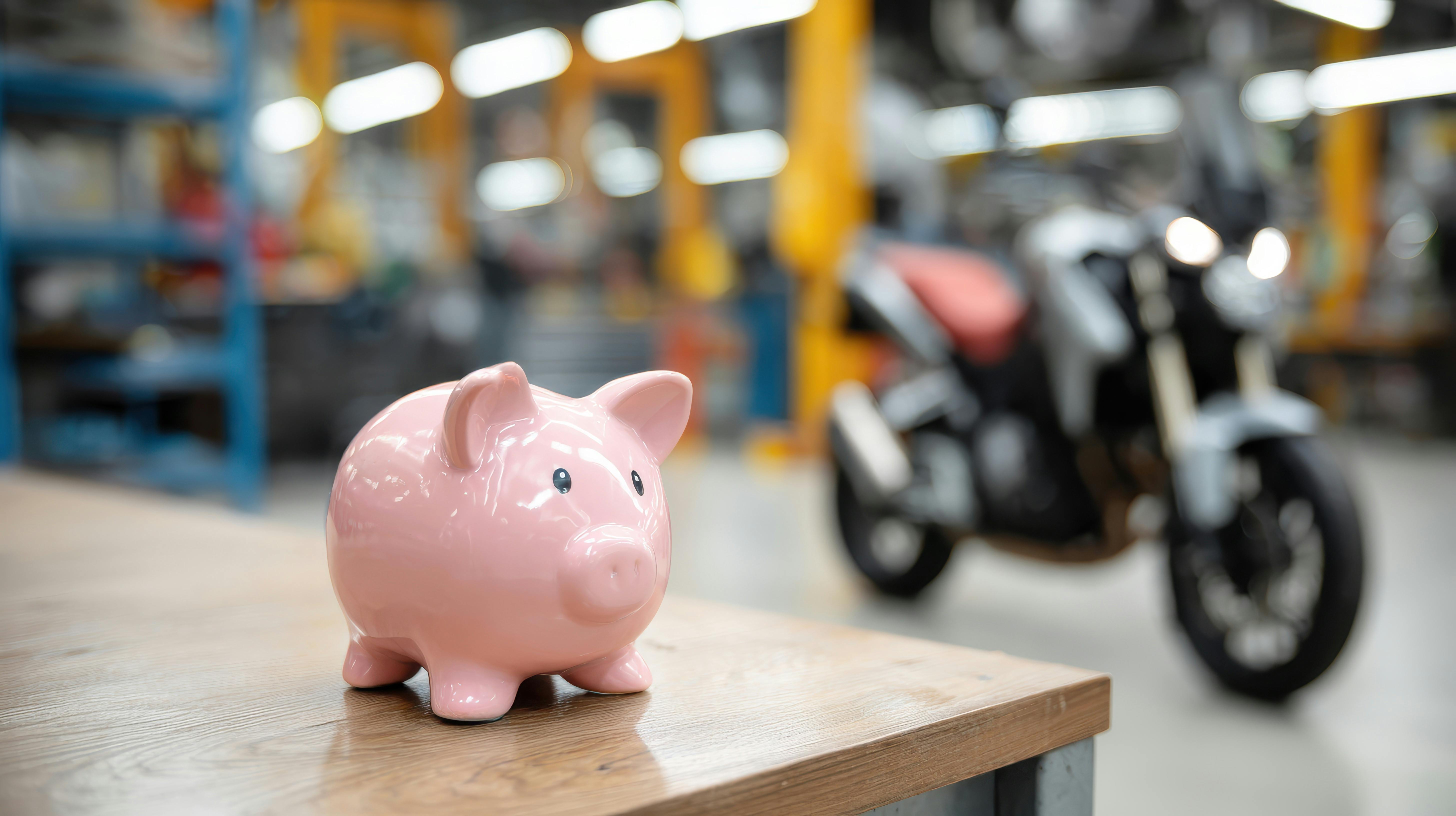 image of piggy bank next to motorcycle - motorcycle rental vs buying