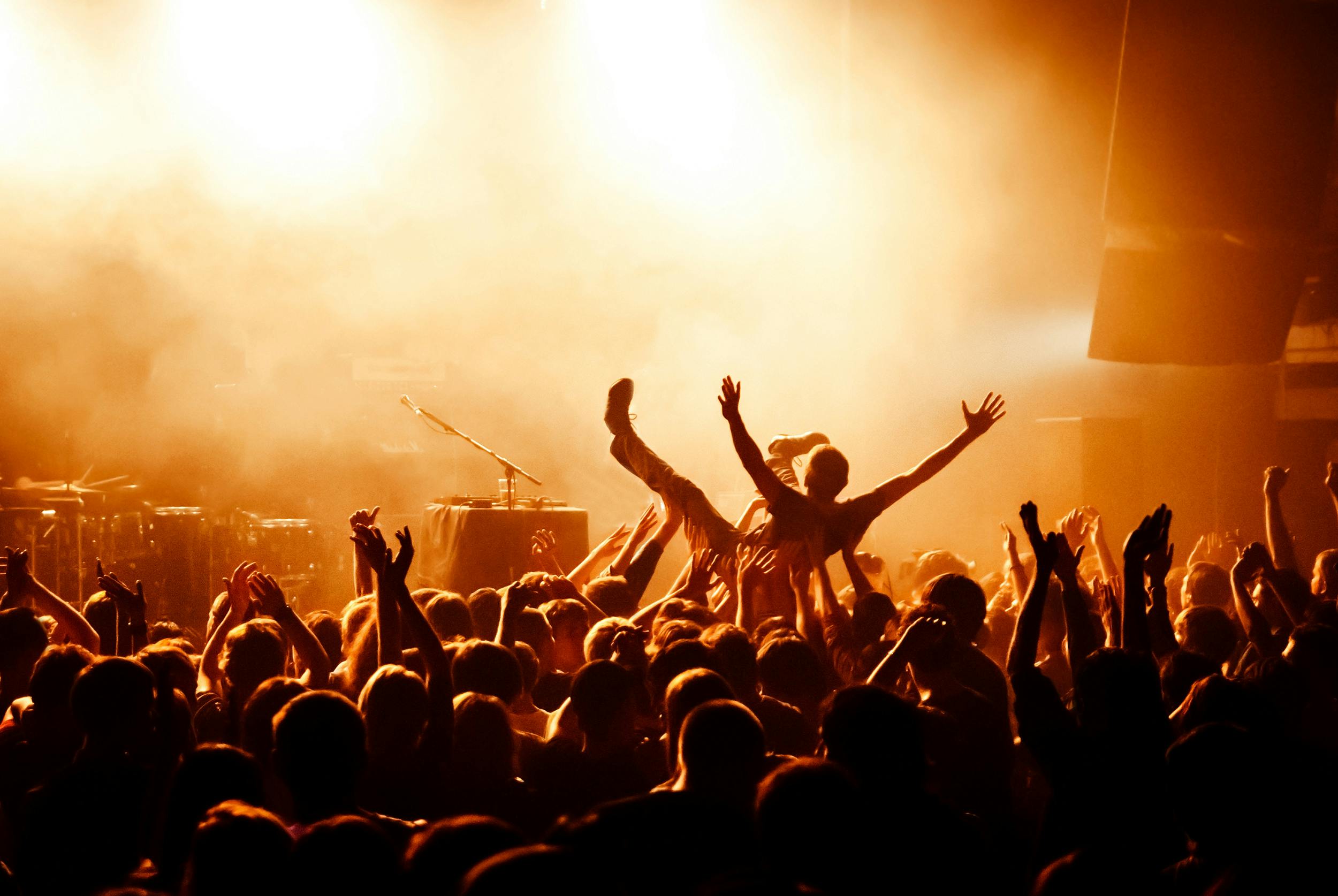 image of crowd surfer at concert - learn Who’s Performing at Thunder by the Bay with Riders Share
