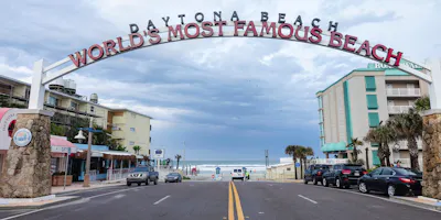 image credit: 4kclips - stock.adobe.com, image of beach sign in Daytona beach - book a daytona beach motorcycle rental with Riders Share