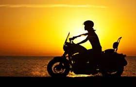 image of rider on a motorcycle on the beach - compare hawaii motorcycle insurance quotes on Riders Share