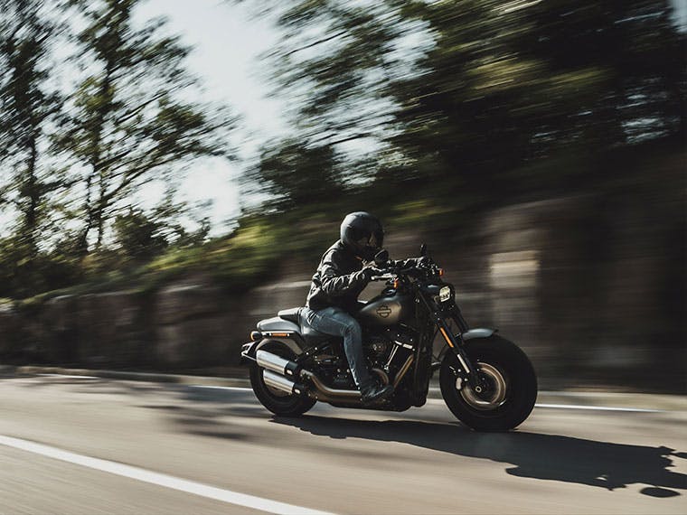 Harley-Davidson Fat Bob motorcycle touring through the countryside.