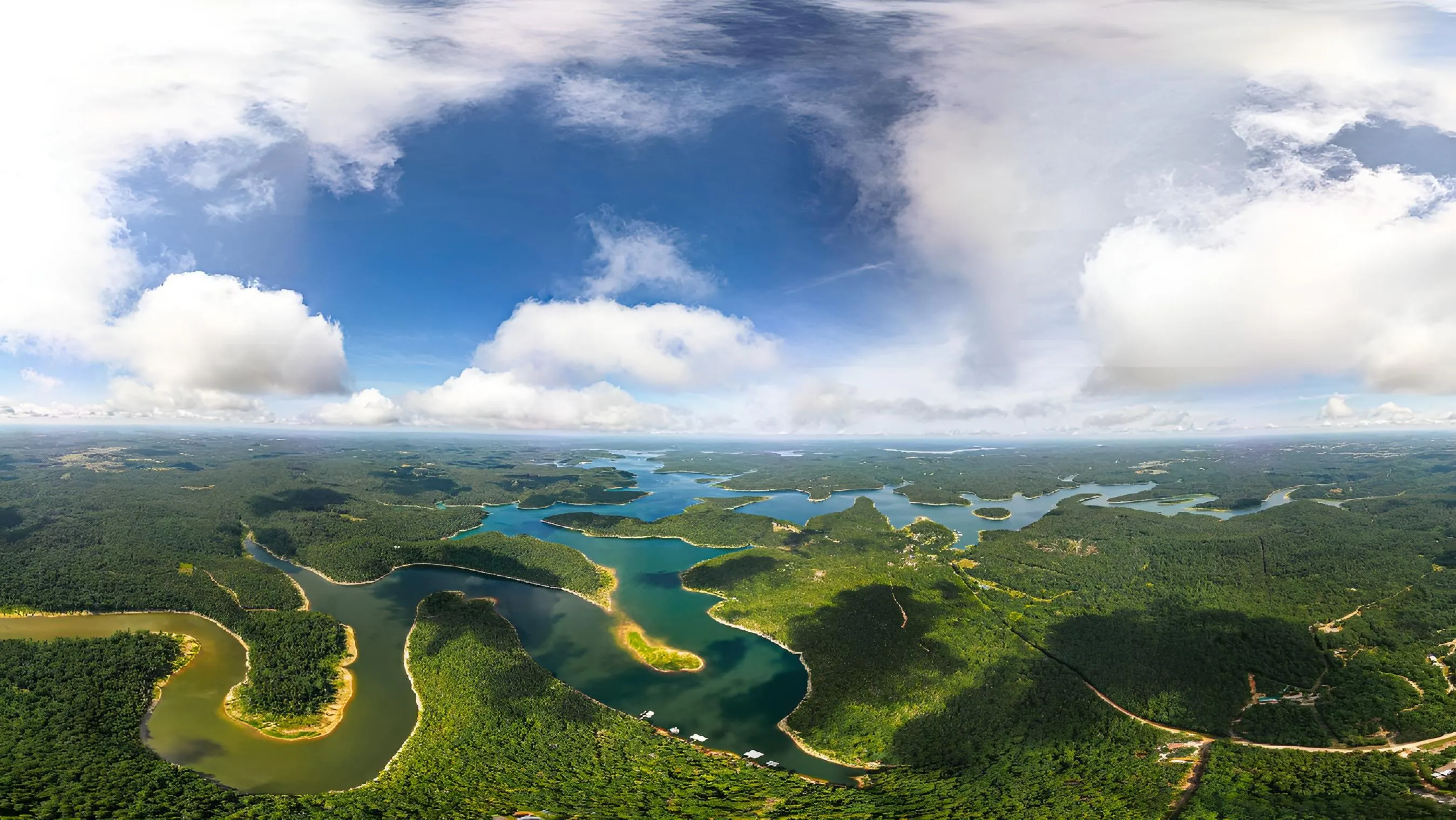 Aerial view of the Arkansas Ozarks with river and forested hills stretching to the horizon