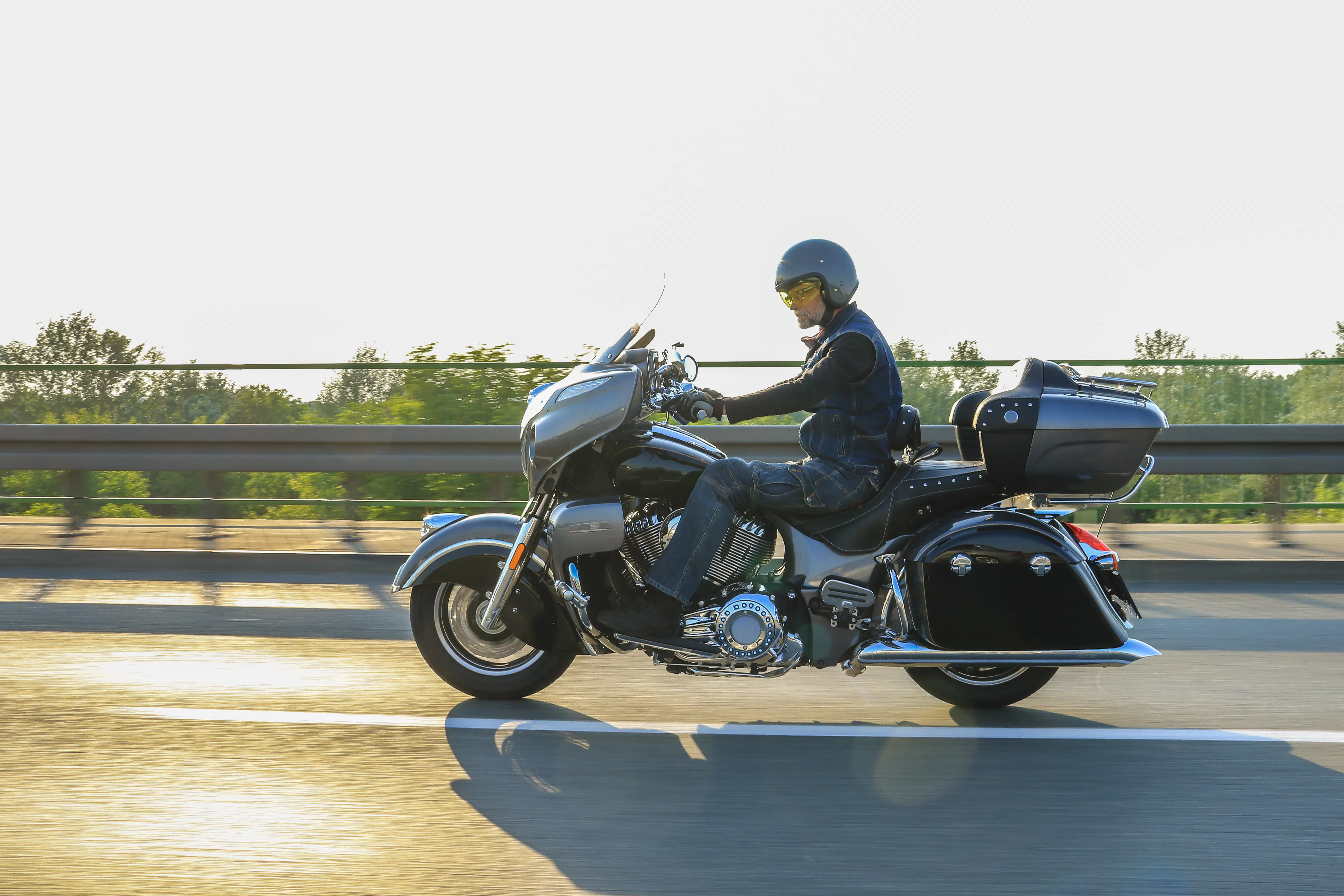 Rider on a touring motorcycle in motion on an open highway