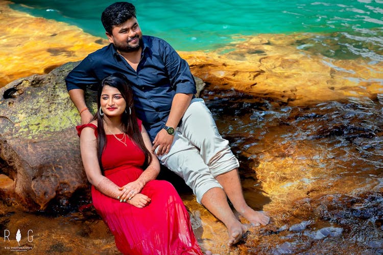 Bride posing with her groom near a sea beach for pre wedding photoshoot