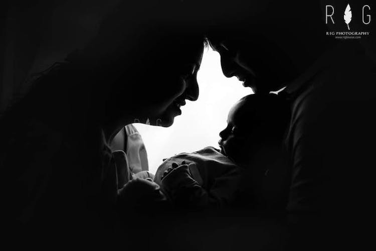 Couple posing with their newborn baby