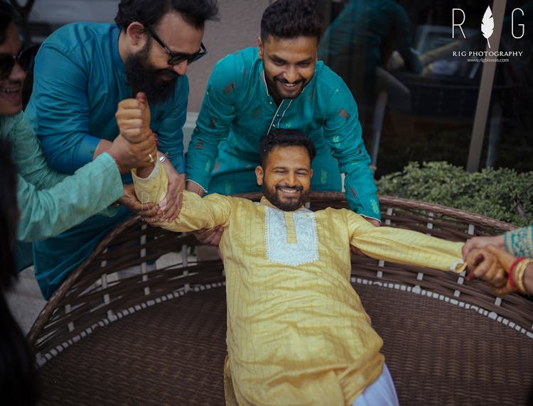 candid haldi poses for groom
