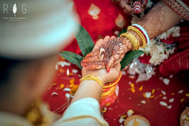 Hands of groom and bride in kanya daan for odia wedding