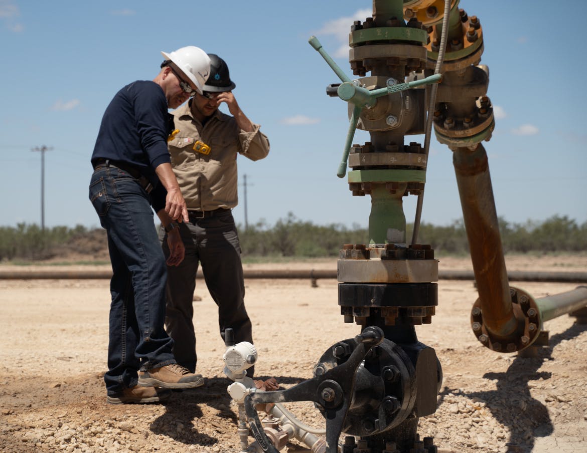 Oil & gas contractors inspect an upstream production site.