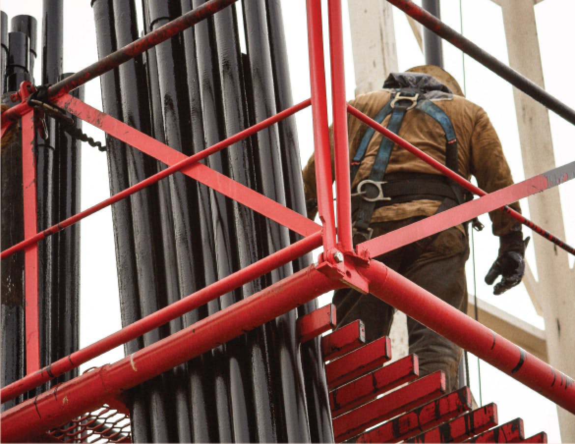 An oil & gas contractor readies pipe segments at a drill rig.