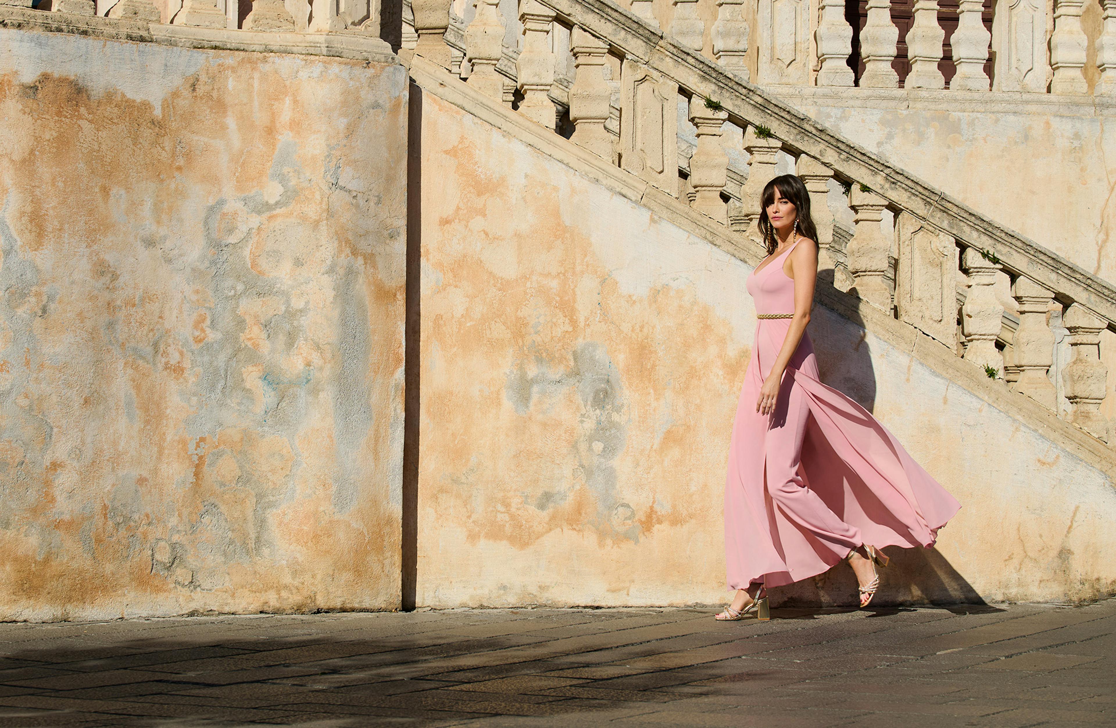 A woman in a flowing pink dress