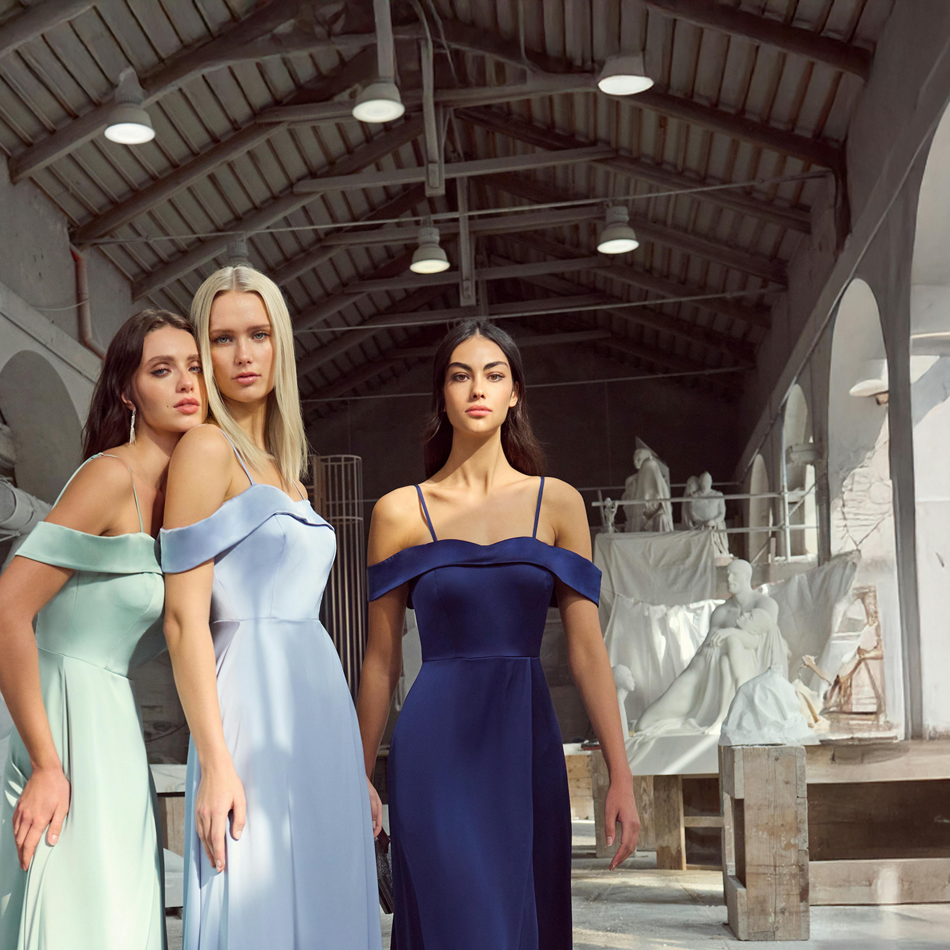 three women in matching elegant dresses