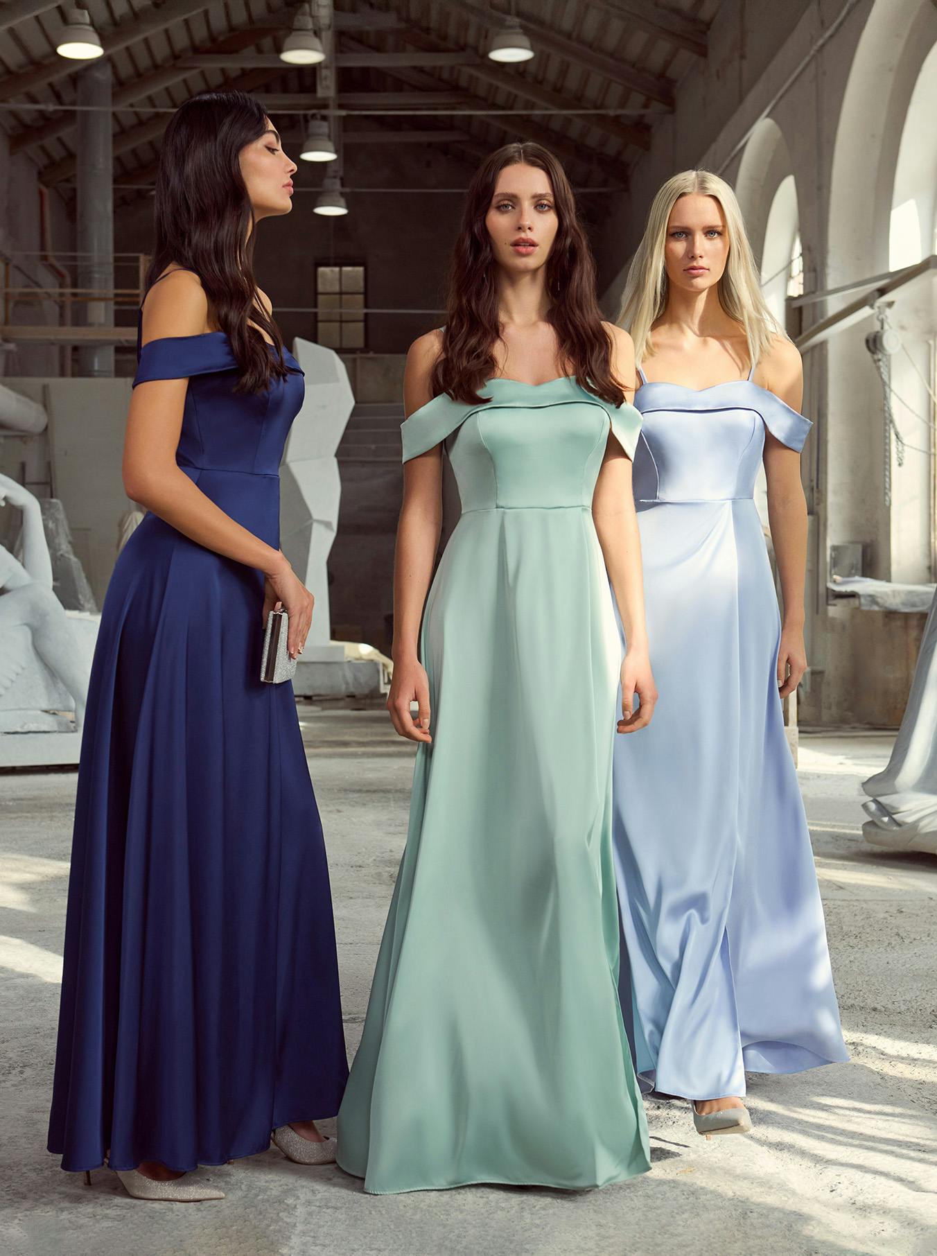 Three models stand with ceremony dresses