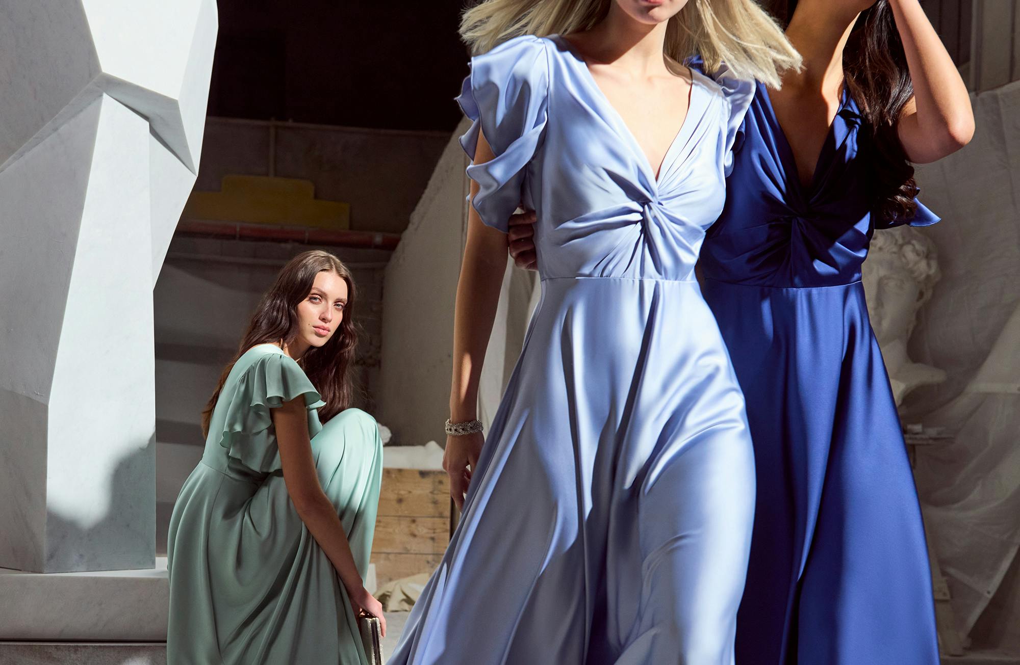 Three women with ceremony and luxurious dresses