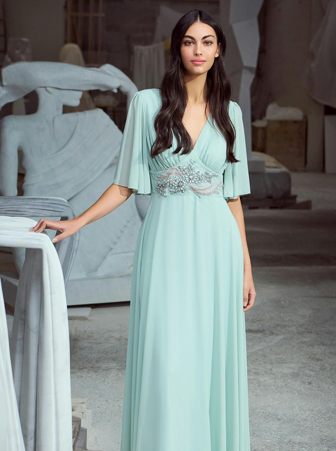 A woman in a flowing mint green dress