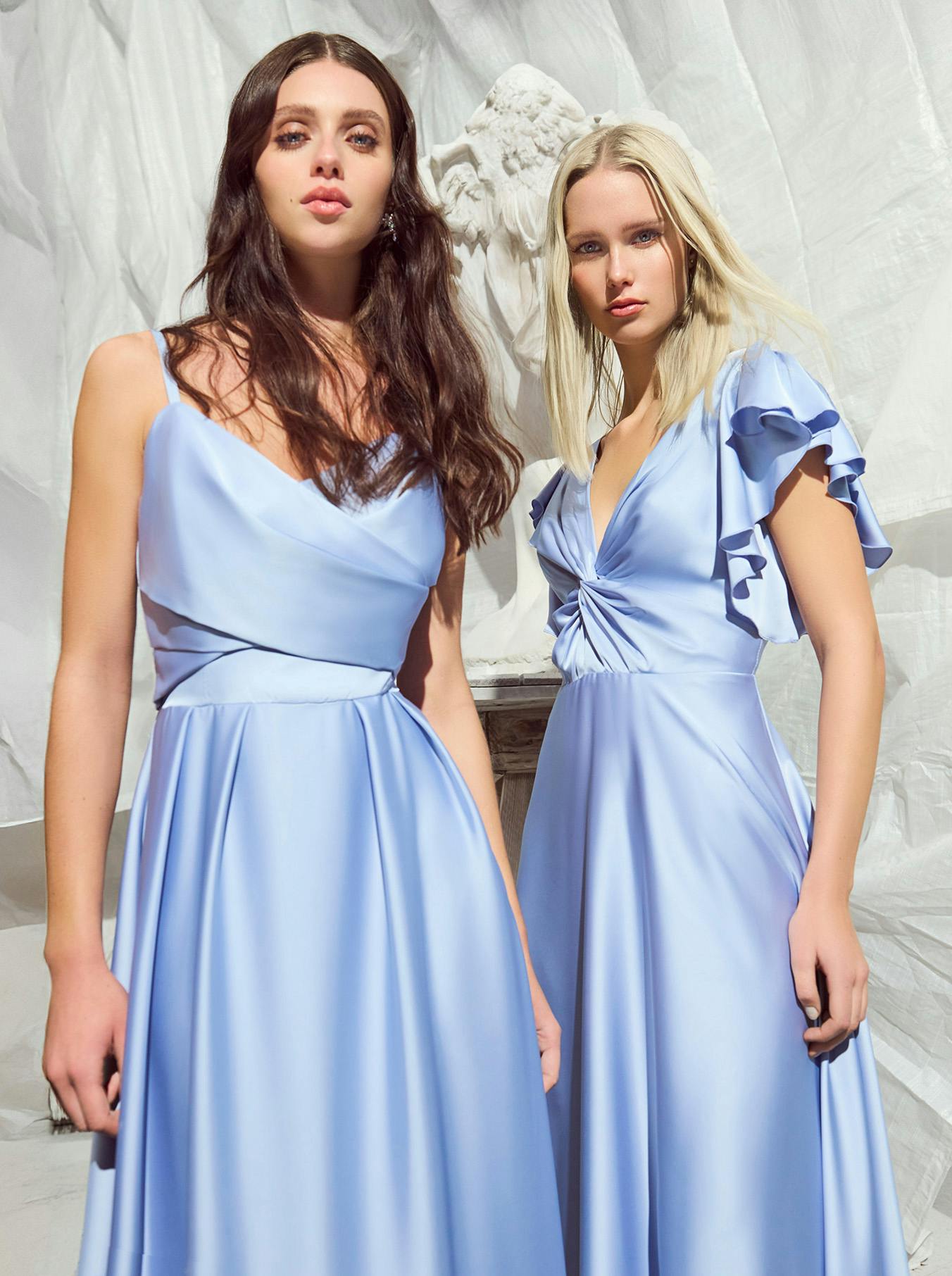 Two women, adorned in beautiful blue dresses