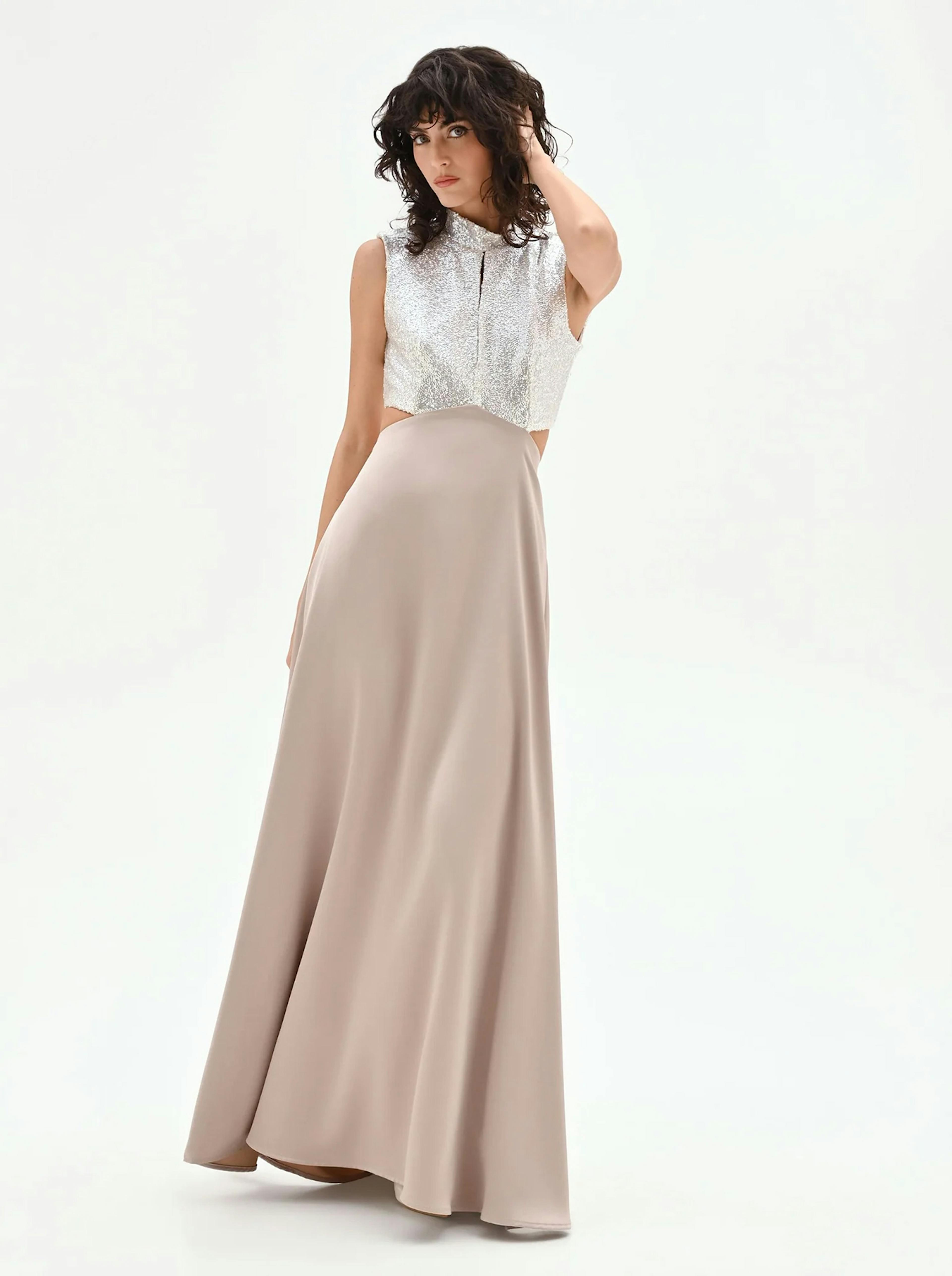 Elegant floor-length evening gown featuring a sleeveless silver sequin bodice with a high neckline and a flowing taupe satin skirt. A sophisticated cut-out maxi dress perfect for gala events, bridesmaids, or formal celebrations.