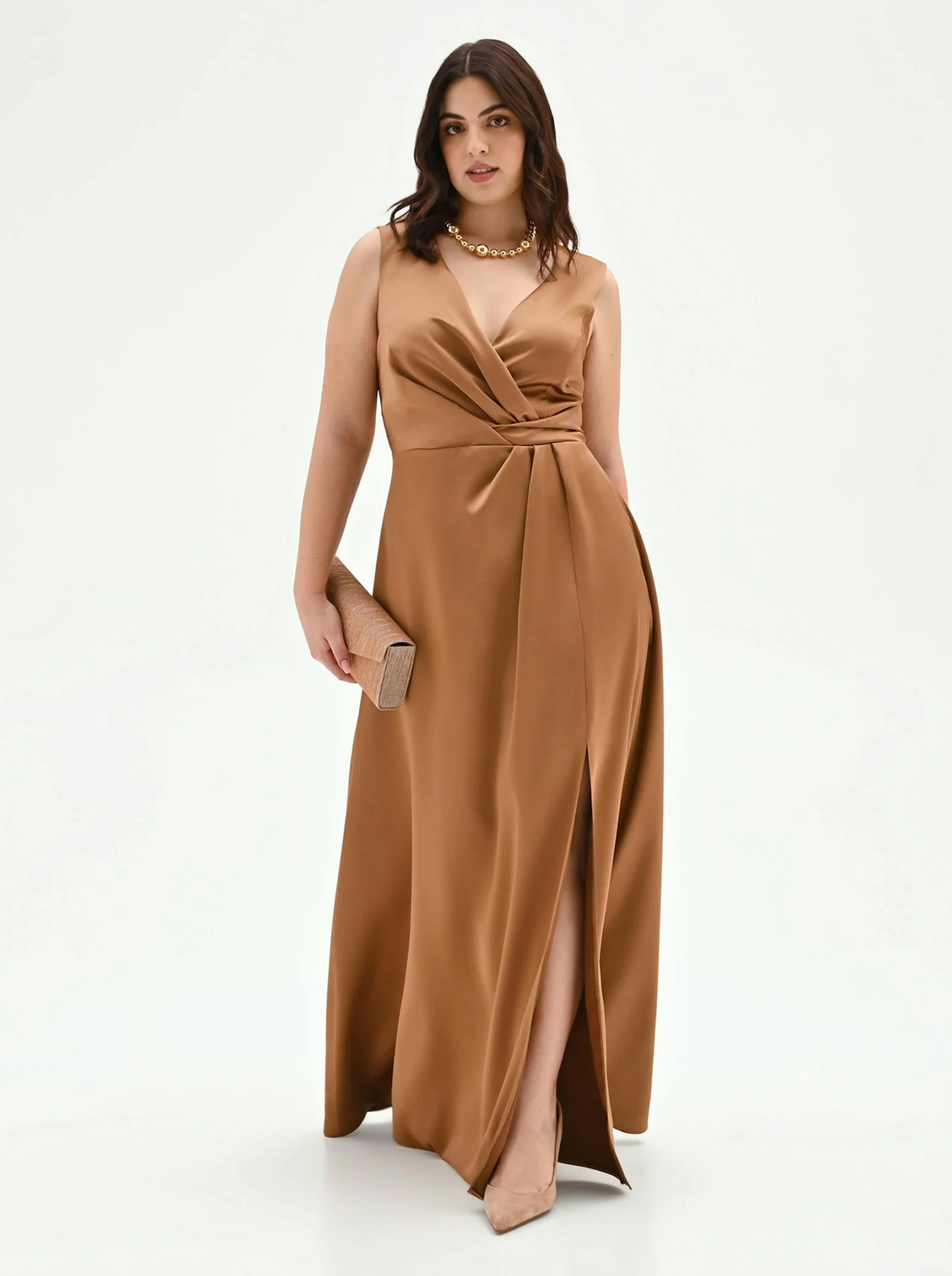 Luxurious bronze-toned silk wrap maxi dress with a deep V-neckline and a high leg slit. The draped bodice and cinched waist create a sophisticated silhouette for formal dinners or cocktail events.