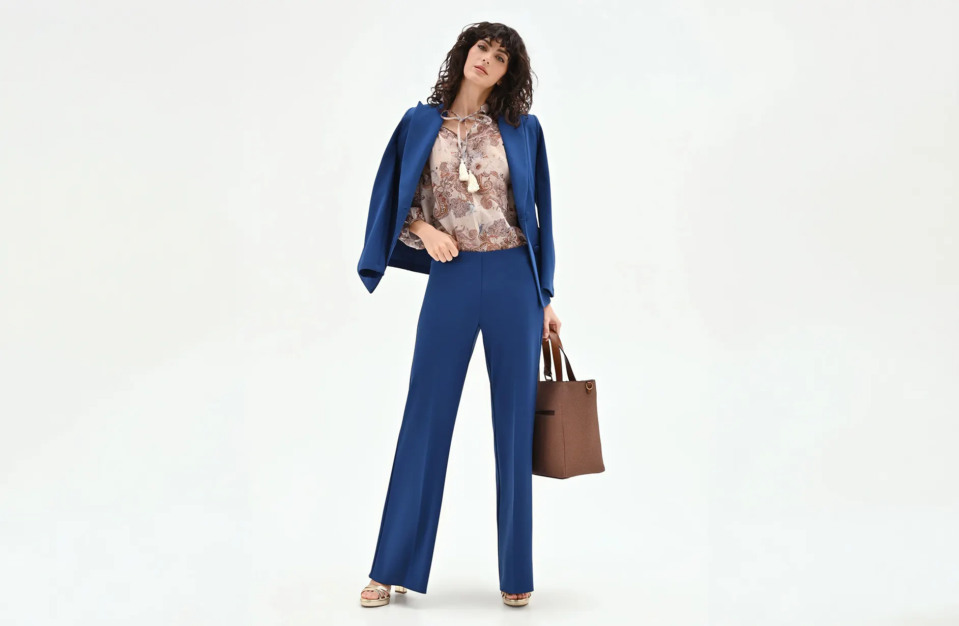 Woman with a blue suit and a printed fantast blouse