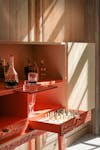Hébé cabinet in gouged wood and coral lacquer, RINCK design © Gaspard Hermach/RINCK