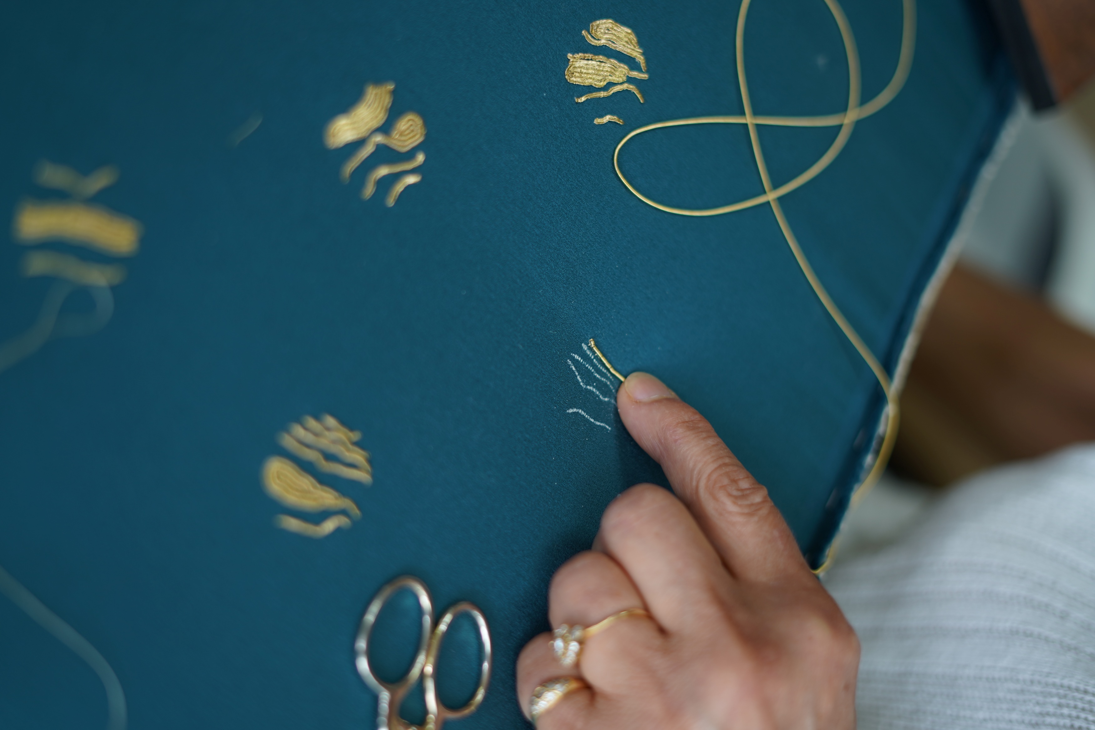 Gold embroidery in progress for the backgammon tokens