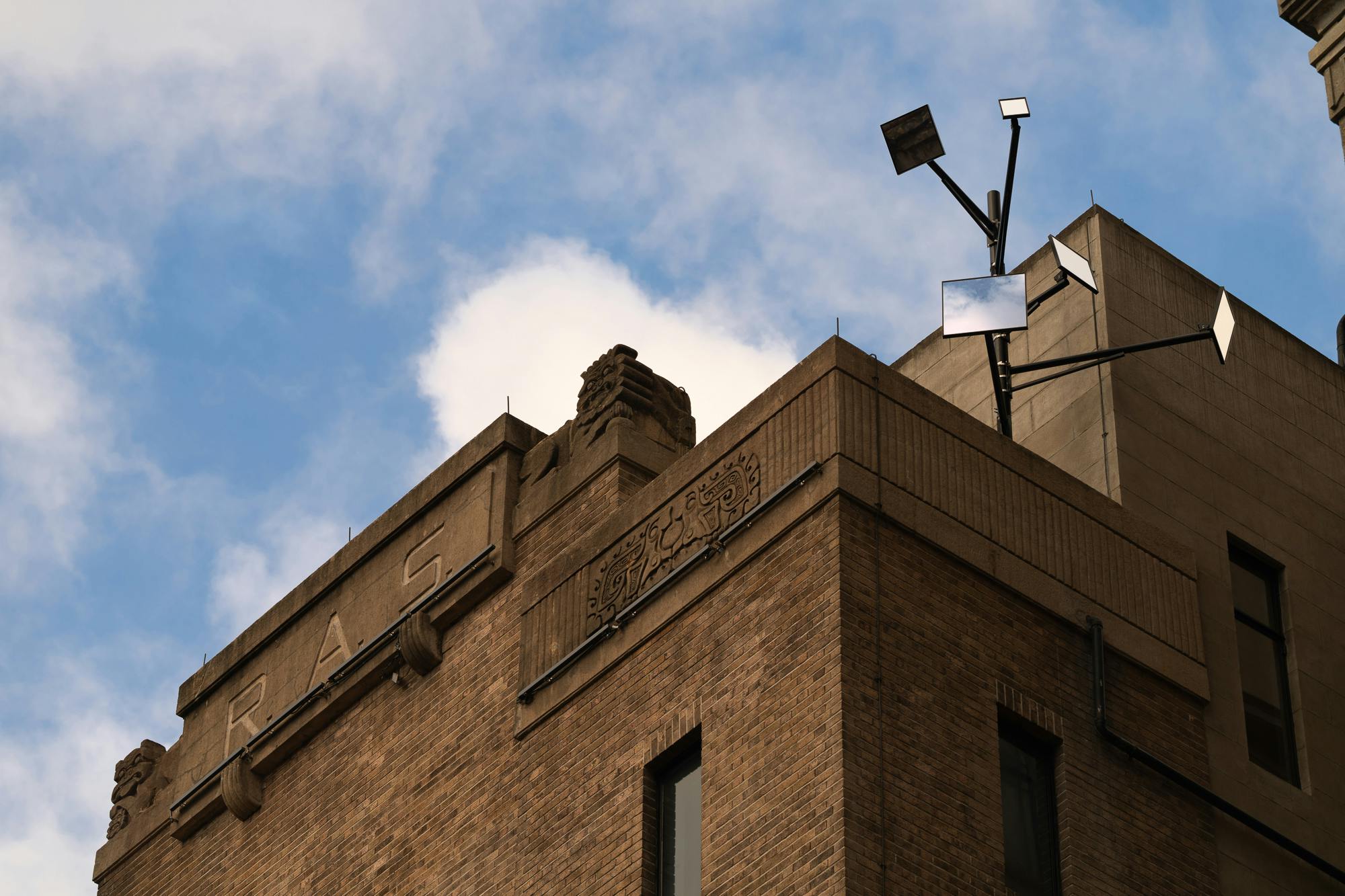 Best Synthetic Answer #3: Protocol Converter Prototype 2024 Mirrors and metal structure Overall dimensions variable This work uses 5 mirrors to create suncats on the opposite building at different times of day, this view is from the 5th floor window. 