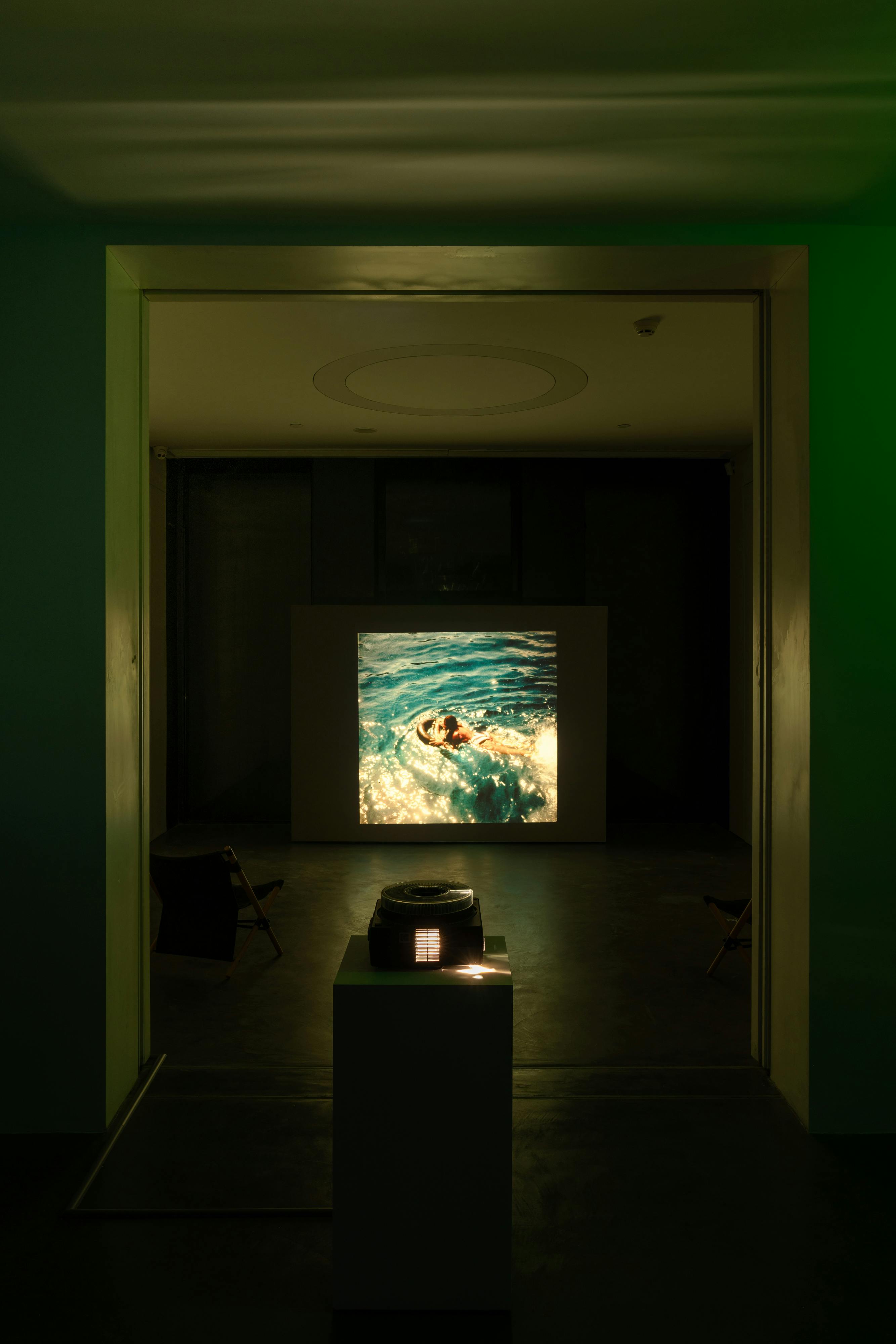 Dark blue of the water, the side to side motion of the boat like take your arm and swing it from side to side like a pendulum, any body part really, your whole body side to side like a pendulum or just your head or your eyes you get the feeling, and sitting along the edges of the boat, inflated, and the pendulum gathering and the hard, industrial, rubbery, plastic seat, squishing with water, slipping, rough and smooth, and the clouds gathering in the air across the island or what I could see of it and my excitement so high and high pitched like my voice a wall of joy and feet simultaneous can you believe I dreamed it and now it is real this I the pacific and there is so much for me to know and all I have done is reflected and refracted and most people say visiting Hawai‘i was the highlight of their lives but what did they visit what did they see who made it so and the rock of the boat faster now and the whale breaching Swimming under the catamaran, the hollowness of the boat looking beath the boat the feeling of the glass, almost foggy, no definitely foggy, but the fish still visible, they moved so much more simply than on the television, like in conversation with the weather as if to say well hello, eating food next to the glass in the bottom of the boat so as to not miss anything, I did not get to drive the boat, not the boat, not the best hot dog either, hard buns and they were never very juicy and several trash cans filled with water to dunk your snorkel, your swim suit, whatever, grilled chicken with nothing on it, put some mustard on that kiddo, says my father half annoyed, half perplexed, the strips of flesh separating in my mouth, I learn later this is muscle, I like muscle but I always felt no feel empty after swimming a kind of exhaustion, I was dehydrated but then I just ate instead of realizing I was dehydrated I could have been 8 in the way I see it but who knows how do you see me, we’d eventually get to the crater which envelopes you, this is annoy phrase envelopes, but it does, it is unbelievable, the edges falling into the ocean like a broken cookie, a sudden fall, I say kind of because you can make out the rocks on the shore but never step on to land, I bet there were munitions in the crater too, I mean in the water too, but who knows now, the water had such a color, so blue and almost jewel like The top of my head has always been sensitive, My family becomes and afterwards and in that process visits Hawai‘i every year A sun shower Here’s a new one for you: we have changed the ocean the air the planet, yes but is it the center of the mile I have changed, my mother has changed, language is our liberation and my father has changed my sibling has changed, imagine trying to catch a 100 mile fast ball in the dark? And change, change is god Right change is god? I don’t know we’ve been mucking about, glasses want to be round and I don’t know if land is a woman, what do I know of land always traversing, bridge calls my back elsewhere who are we here change is god, a swam without a neck did not easily dissolve I don’t remember learning how to swim, I just did it, my mom says that’s not what happened, a black child must know how to swim, did you know all the sizes waves could be or that whales thumbprints are their tails I’d like to start tearing seams in the future, tearing a seam into the future (We are all black behind the ear) What’s the work for its falling apart, falling asleep to someone eating an apple, open your teeth, people close to me including myself spare dirt of the situation is the 1 point of language to communicate and be understood? You shout coming around the corner No stupid questions! “Bother me killjoy” OPEN YOUR TEETH, be the gift horse, copiable all together, consumptive, I was always happy to feel small as long as I knew I’d be big again, how’d I get here and what can I do with all this memory. 2024 560 35mm color positive slides This slide show alternated each month of the crossing journey, showing my family’s archive of photographs of our time in the pacific in San Francisco and Hawaii. 