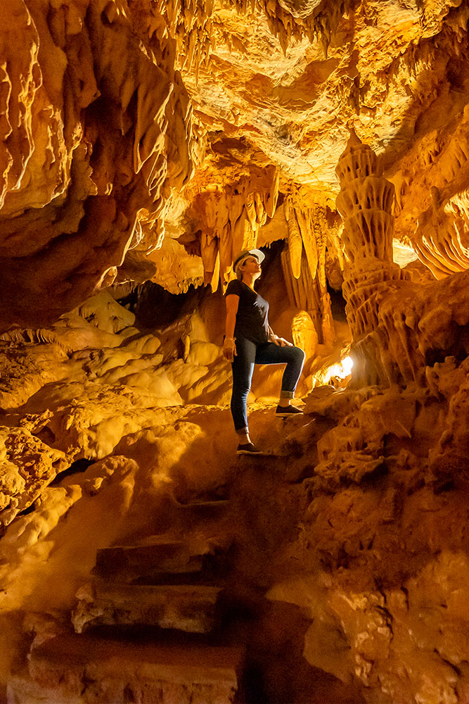 Imagem impressionante do interior de uma caverna com cores vibrantes de laranja e amarelo, criando um cenário natural deslumbrante para os amantes da natureza.