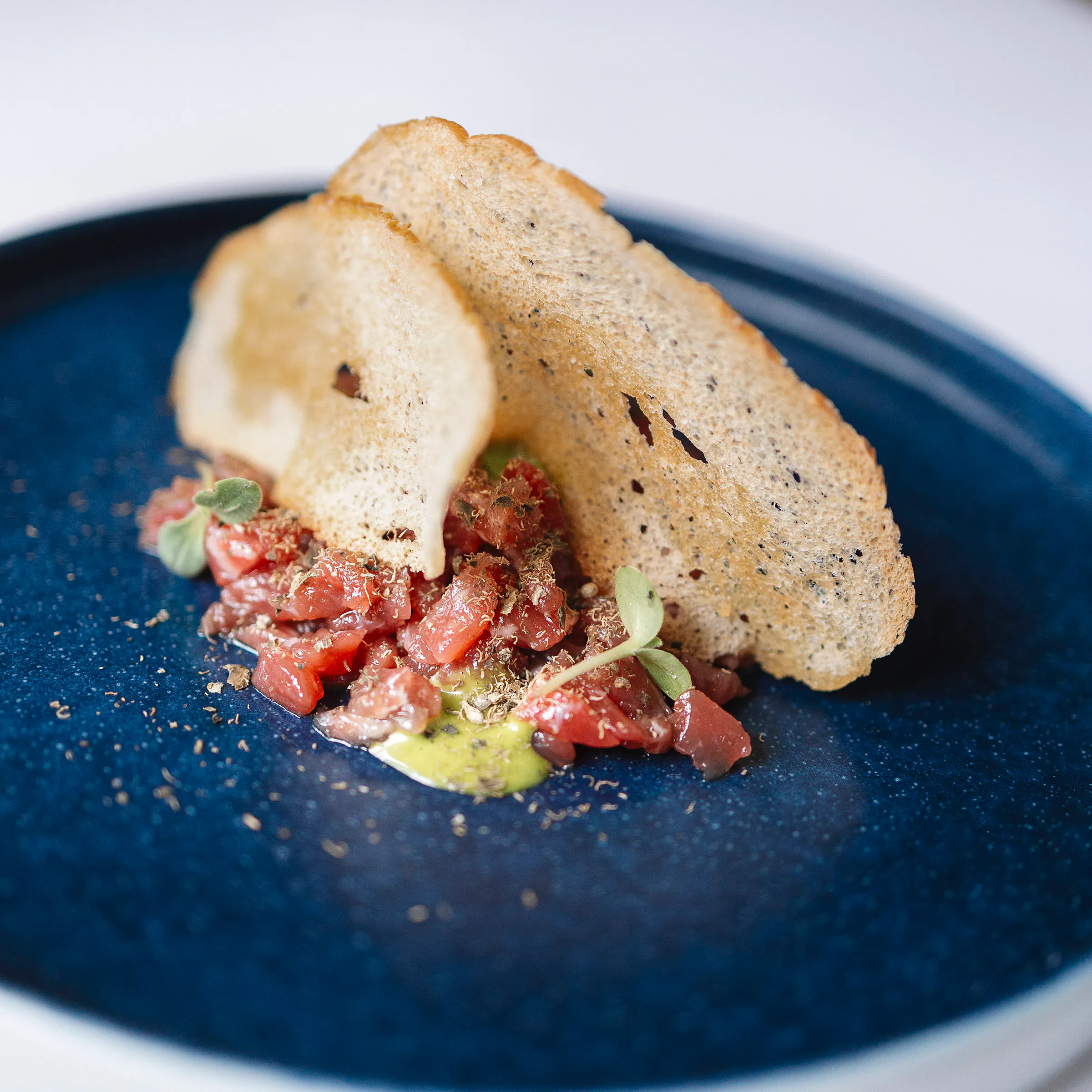 Tartare di manzo marinata con polvere di cappero, chips di pane e maionese al sedano