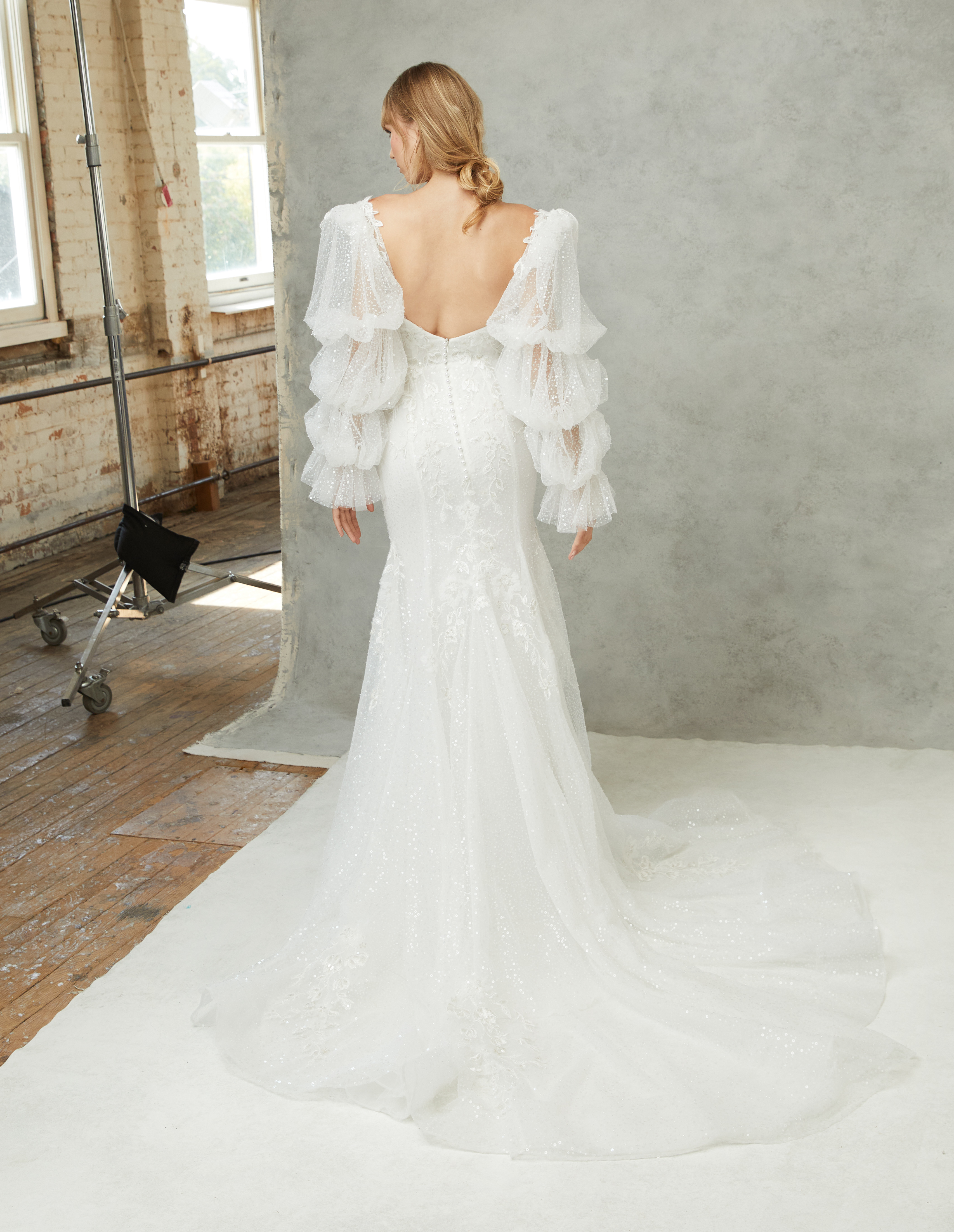 Eloise strapless sweetheart gown with gored fit-and-flare skirt and detachable puff sleeves, shown from the back.