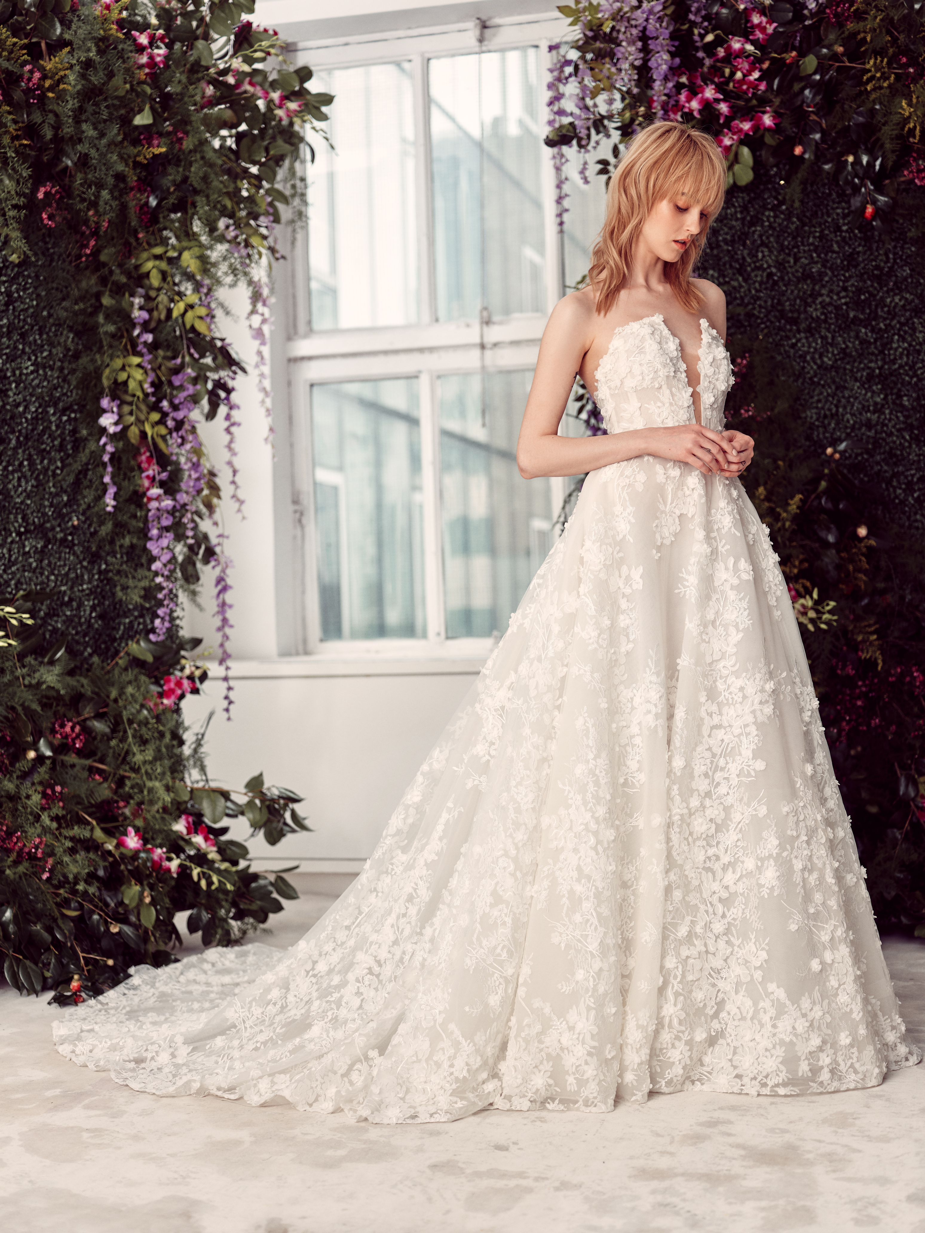Bride wearing the Reagan lace ballgown with a full skirt and floral lace train.