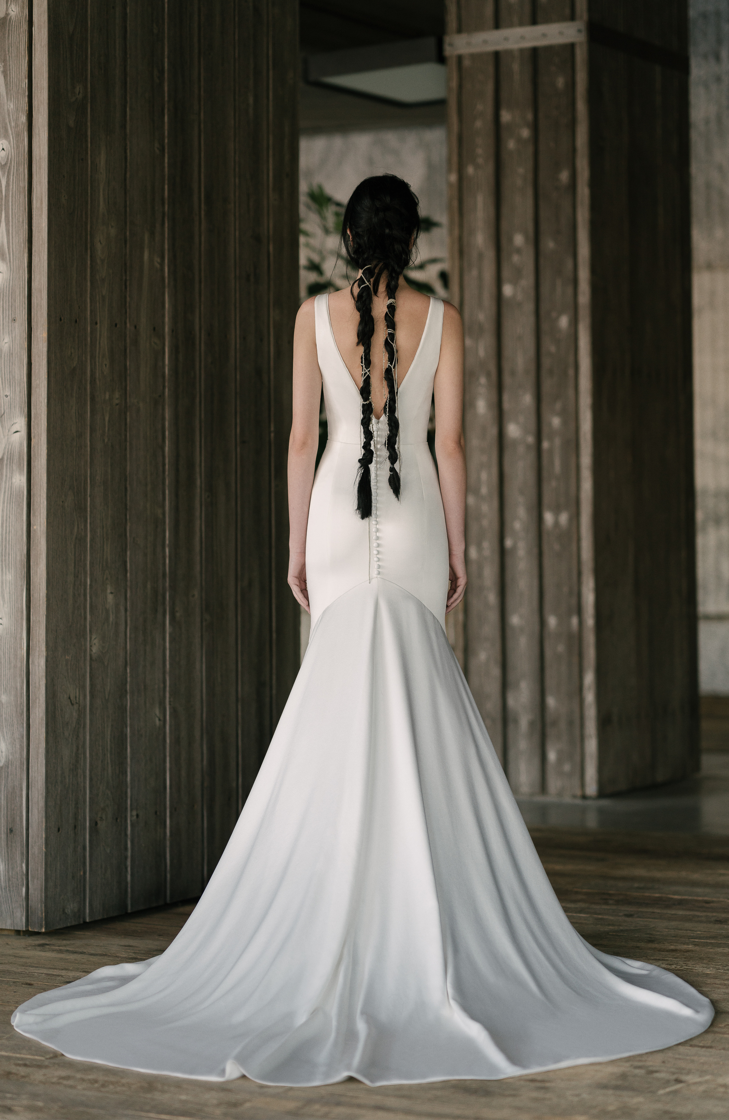 Back view of the Roberts gown, showing the flared sheath silhouette, low back, and soft train.